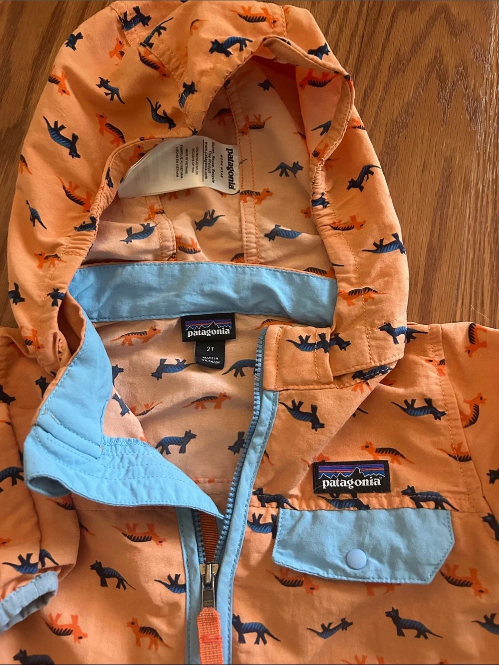Patagonia Kids Orange Jacket with Blue Trim and Animal Print
